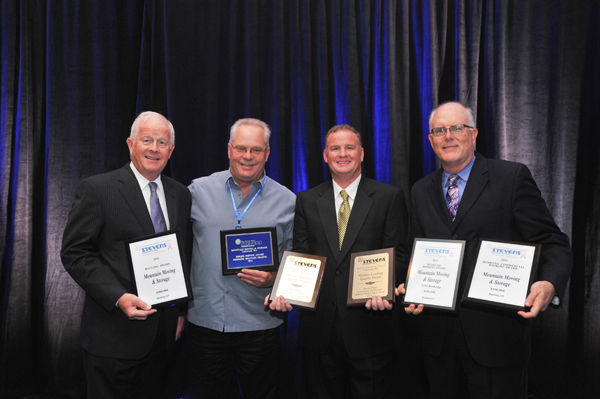 Mountain Moving & Storage accepts awards from Stevens at convention Moving Company Accepts Awards