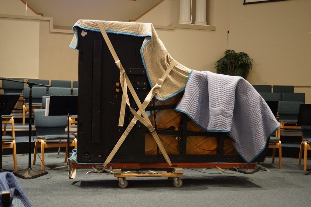 Wrapped Piano Piano Movers wrap a large school piano