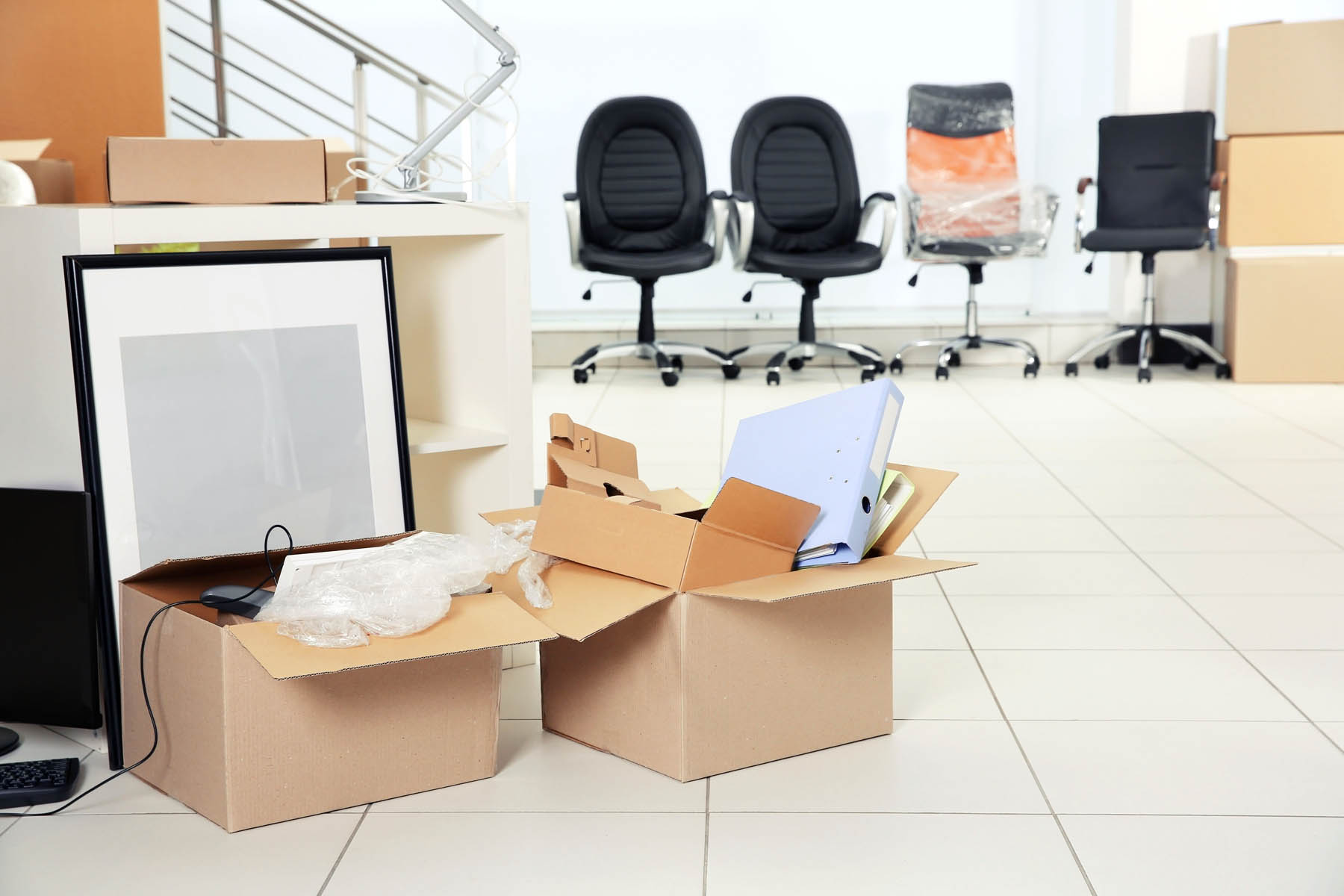 Move concept. Unpacking cardboard boxes in a new office