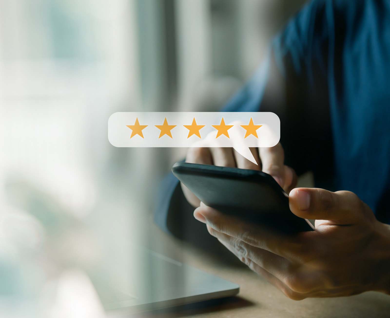 Customer reviewing company with a 5-star review on phone